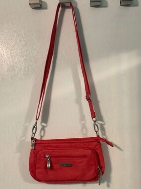 Baggalini orange/peach shoulder bag with multiple pockets and compartments